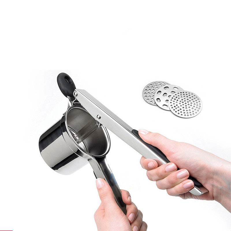 Hand holding the potato ricer with interchangeable discs
