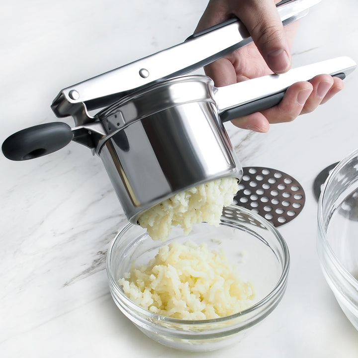Ricer producing fine mashed potato ribbons