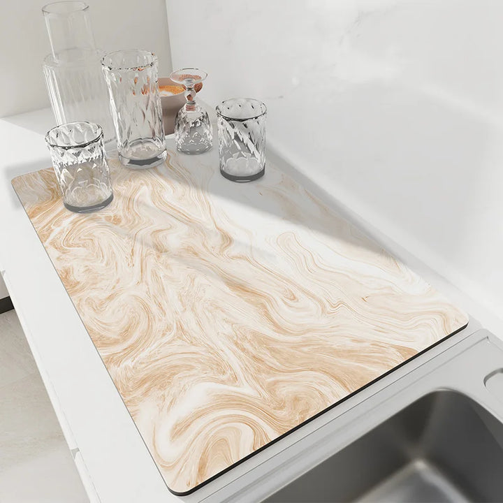 Beige swirl marble absorbent dish drying mat on a kitchen counter