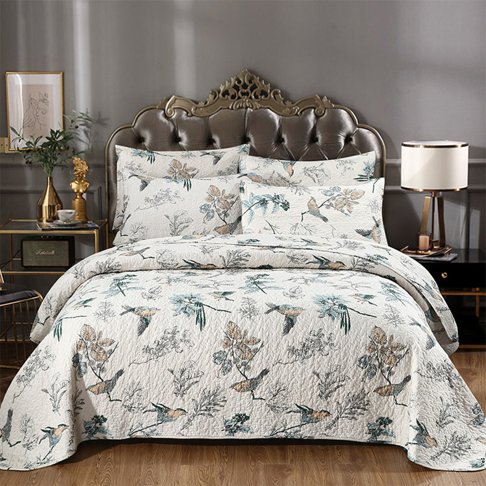 Floral cotton quilted coverlet set on bed pastoral print
