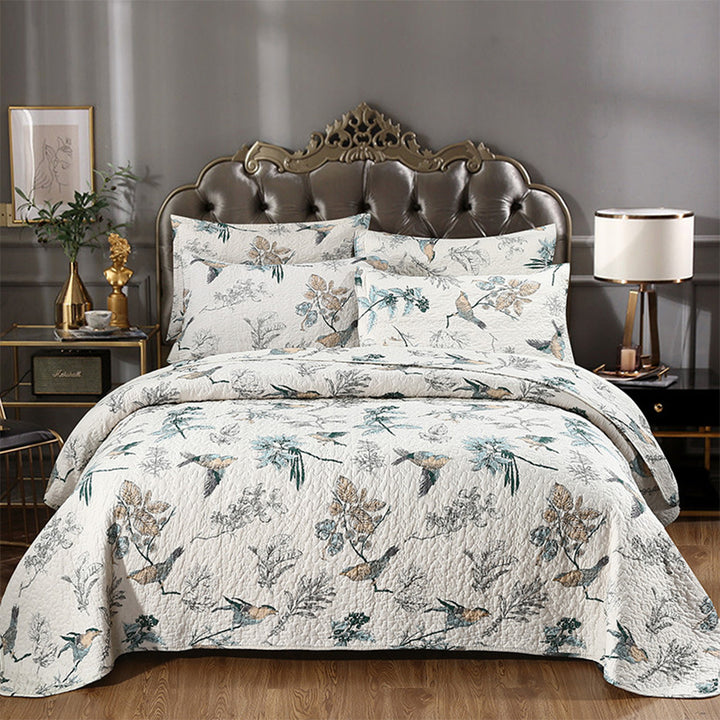 Floral cotton quilted coverlet set on bed pastoral print