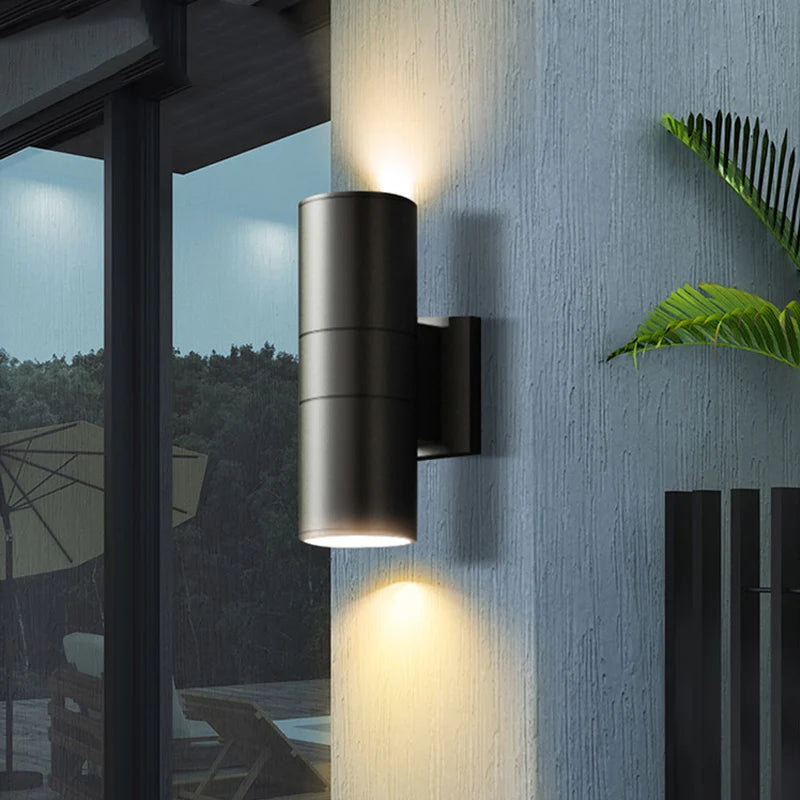 Black round up down outdoor wall light on modern porch