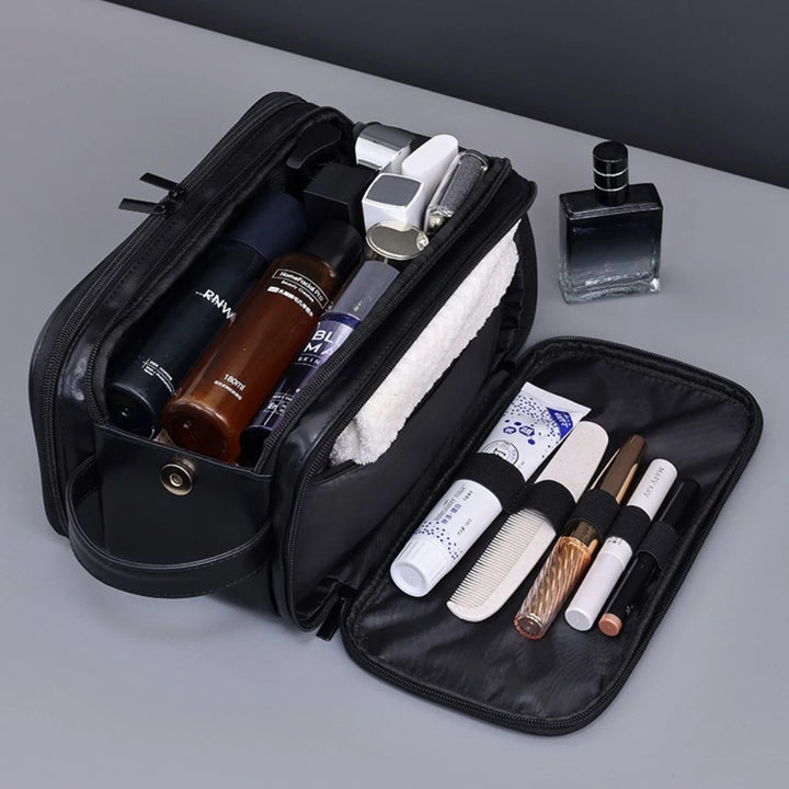 Black toiletry bag showing center storage and elastic organizer loops