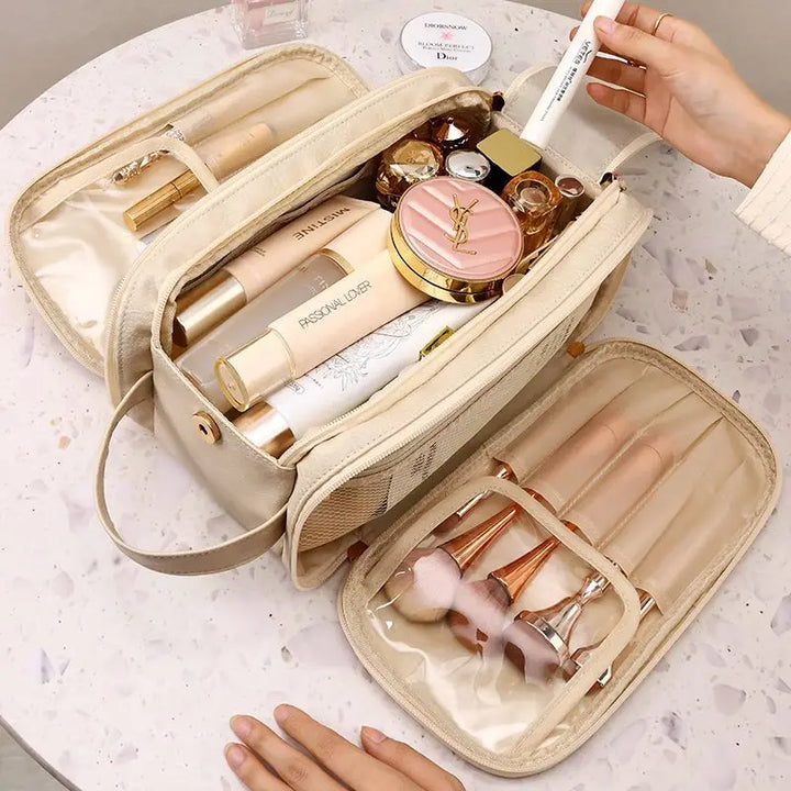 Beige makeup bag opened to show center storage and brush compartments; accessories not included