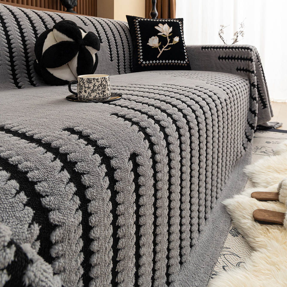 Light grey plush tufted velvet sofa cover in a living room