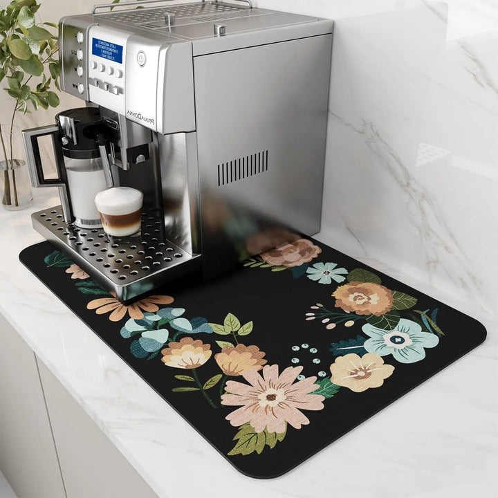 Black coffee mat with floral border under a coffee machine
