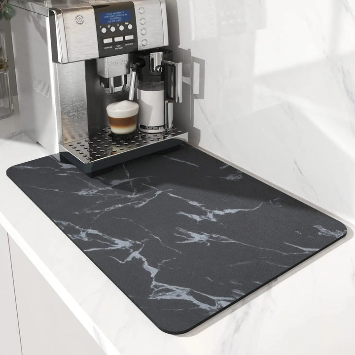 Dark gray marble coffee mat under a coffee machine