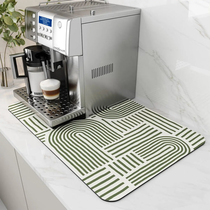 Cream coffee mat with green arch stripe pattern on a countertop