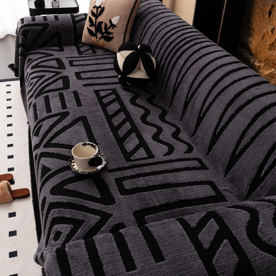 Bohemian jacquard sofa cover with maze pattern in charcoal on a couch