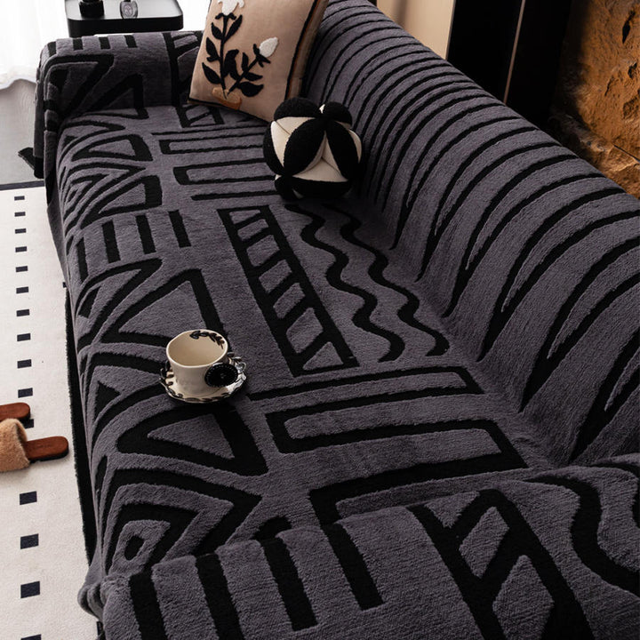 Bohemian jacquard sofa cover with maze pattern in charcoal on a couch