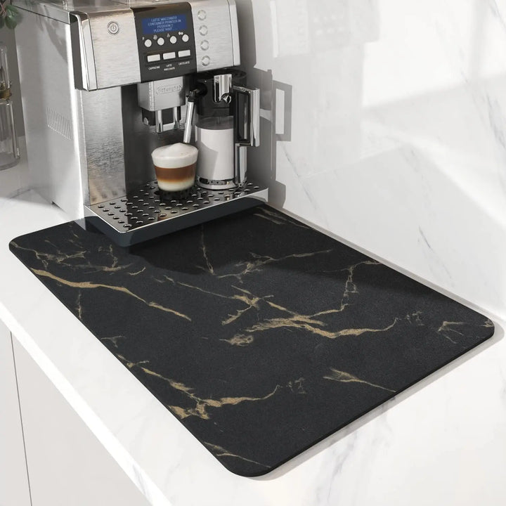 Black gold marble coffee maker mat on a countertop