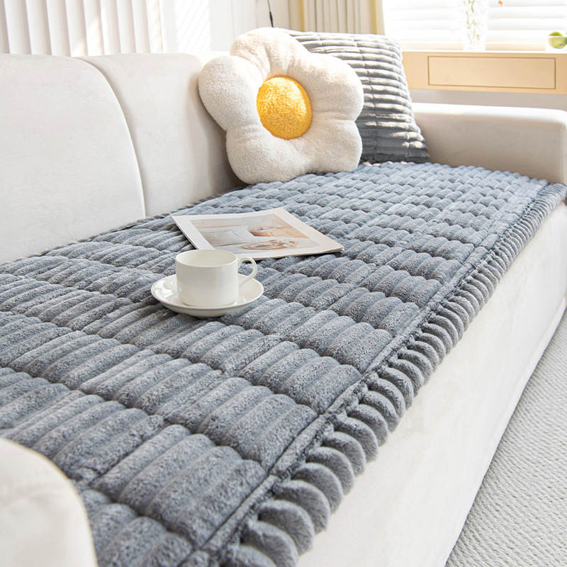 Corduroy sofa cover draped over a living room couch, non-slip plush protector