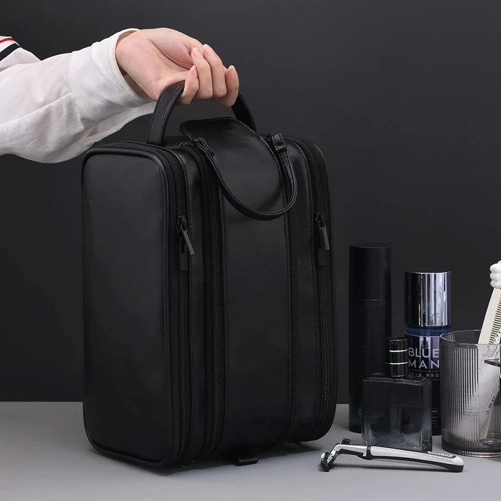 Black toiletry bag carried by its side handle